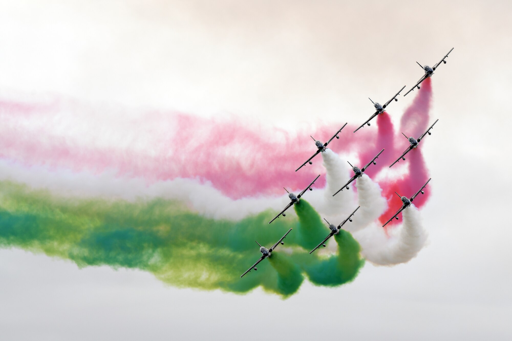 planes in sky with color exhaust