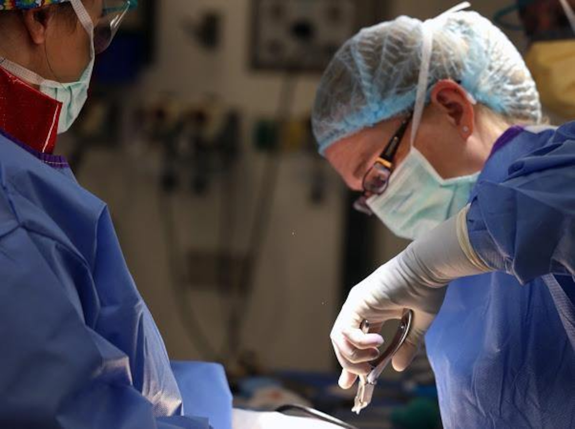 Maj. (Dr.) Jennifer Waterman, performs surgery on a patient in her civilian role at a hospital in Kansas. She is currently an orthopedic surgeon newly relocated from Kansas to Maine.