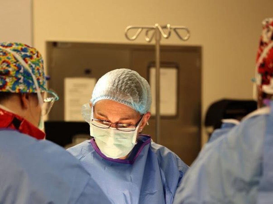 Maj. (Dr.) Jennifer Waterman, performs surgery on a patient in her civilian role at a hospital in Kansas. She is currently an orthopedic surgeon newly relocated from Kansas to Maine.