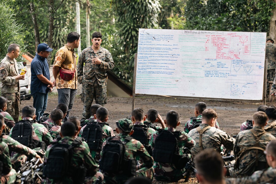 U.S. Marine Corps Sgt. Brayden Layumes, right, a platoon sergeant with 1st Battalion, 7th Marines, attached to Marine Rotational Force-Southeast Asia, leads a period of instruction on patrol base operations to Indonesian marines with 4th Marine Infantry Brigade, Pasmar 1, during Keris Marine Exercise 2023 at Piabung Training Area in Sukabumi, West Java, Indonesia, Nov. 26, 2023. Keris MAREX is a bilateral exercise led by the U.S. Marine Corps and the Indonesian Marine Corps, or Korps Marinir, to promote military interoperability and maritime domain awareness capabilities, strengthen relationships, and expand military capabilities among participating forces in the advancement of a Free and Open Indo-Pacific. MRF-SEA is a Marine Corps Forces Pacific operational model that involves exchanges with subject matter experts, promotes security goals with Allies and Partners, and positions I MEF forces west of the International Date Line. (U.S. Marine Corps photo by Sgt. Shaina Jupiter)