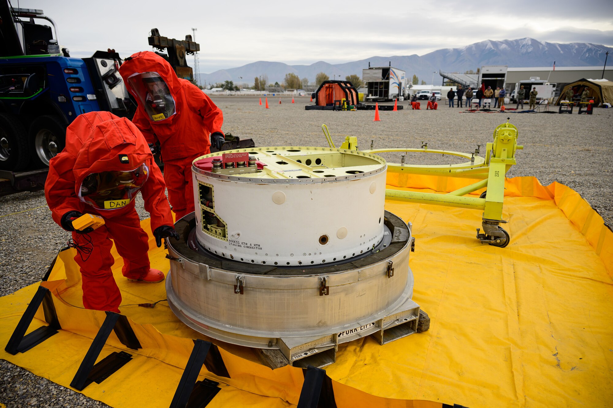 Members of the Missile Mishap Recovery Team take atmospheric samples during an exercise simulating a transportation accident involving a missile component containing hazardous material at the Box Elder County Fairgrounds, Tremonton, Utah, Nov. 2, 2023. The MMRT is on call 24/7, 365 days a year to respond to any number of situations involving an intercontinental ballistic missile where technical procedures do not exist to address the mishap or the loss of life is possible. (U.S. Air Force photo by R. Nial Bradshaw)