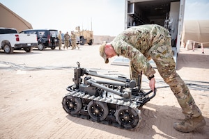 Explosive ordnance disposal Airman checks the batteries on an EOD robot before conducting a suspicious package exercise at an undisclosed location in the U.S. Central Command area of responsibility.