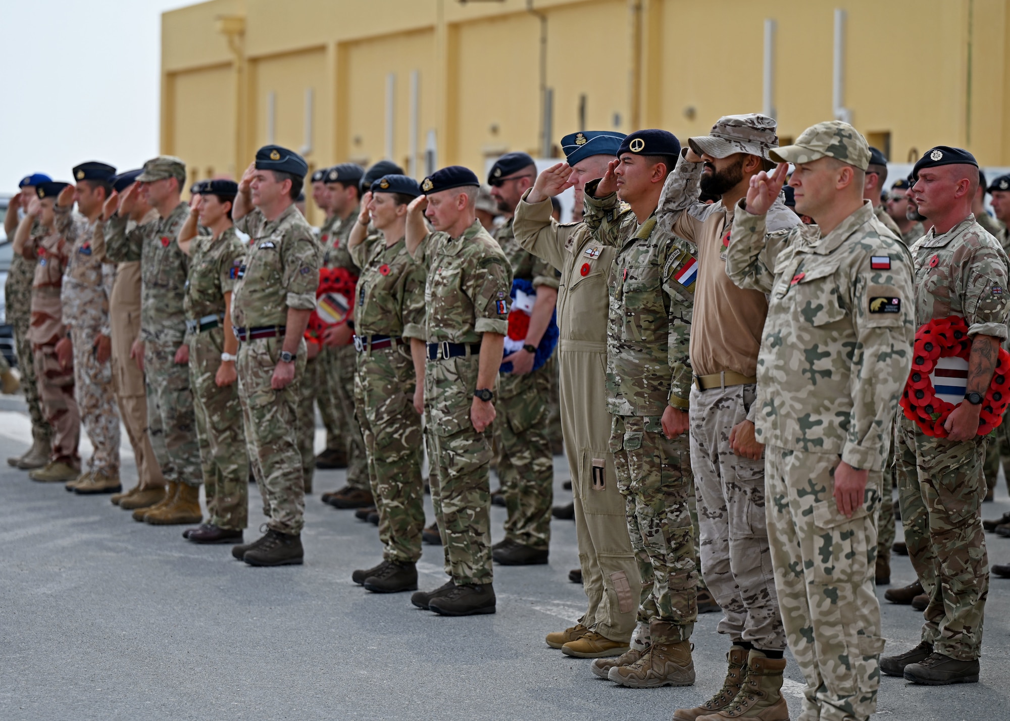 Senior Military officers from nine nations salute during Remembrance Day.