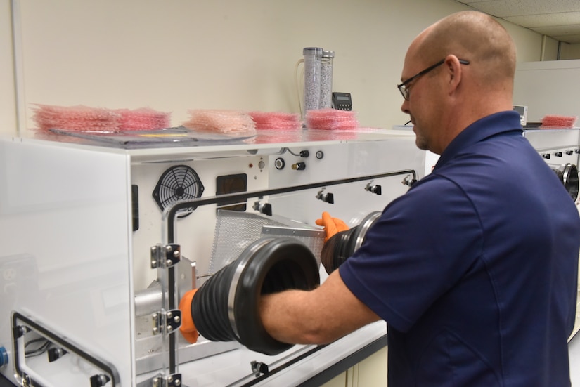 Lab manager Michael Ruff using a piece of equipment in the PHS&T Lab at Naval Air Warfare Center Aircraft Division Lakehurst. (U.S. Navy photo)