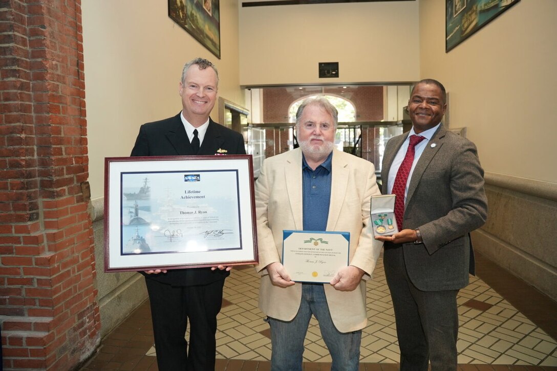 Naval Surface Warfare Center, Philadelphia Division (NSWCPD) Commanding Officer Capt. Joseph Darcy and NSWCPD Technical Director Nigel C. Thijs, SES, present the Lifetime Achievement Award to Thomas Ryan for his critical work and support of test sites over a forty-year career span. NSWCPD employees were recently honored during the organization’s 2023 Command Awards Ceremony. (U.S. Navy Photo by Chief Petty Officer Chad M. Butler/Released)