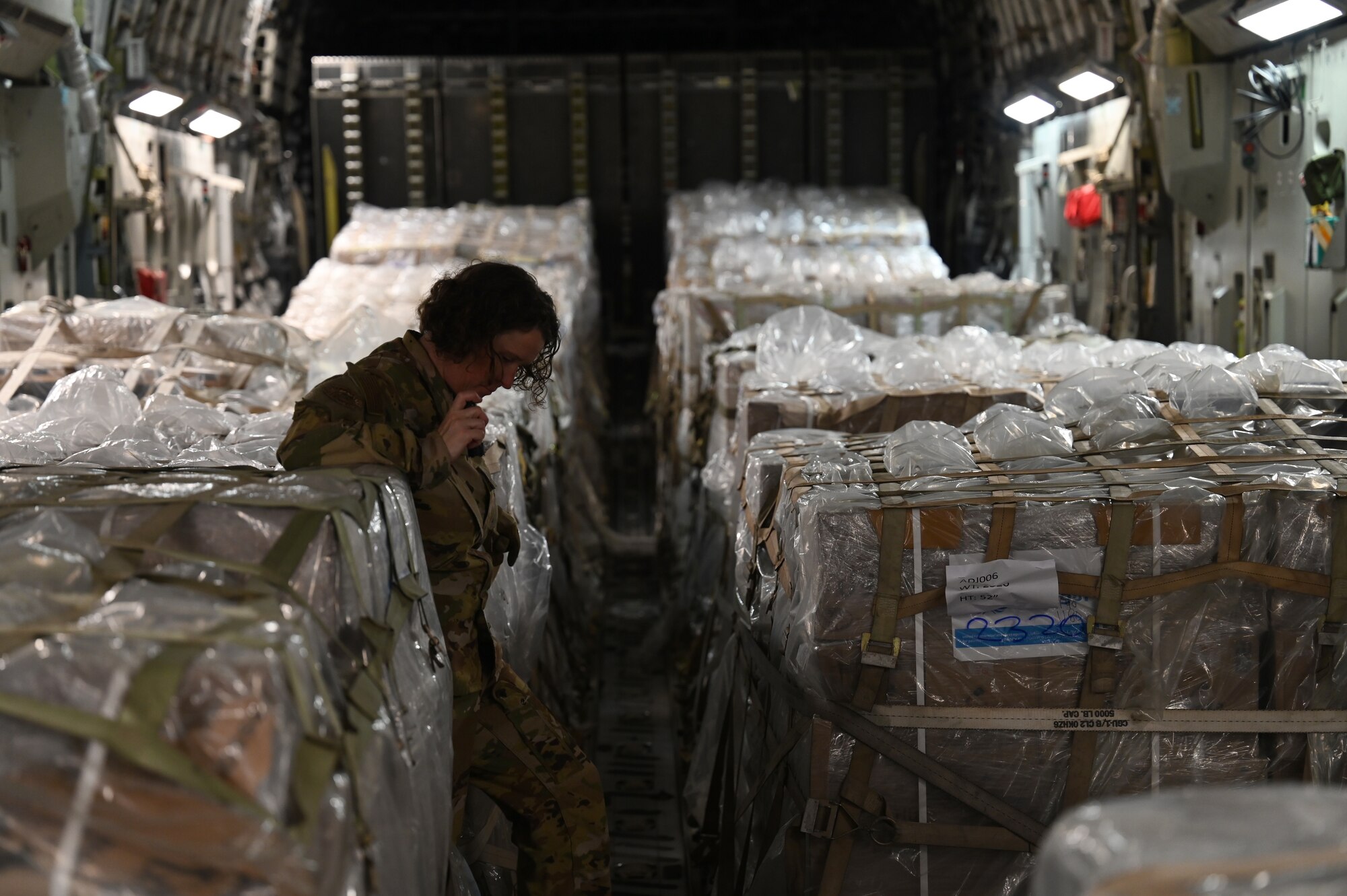 Master Sgt. Caroline Sussman inspects humanitarian aid loaded aboard a C-17.