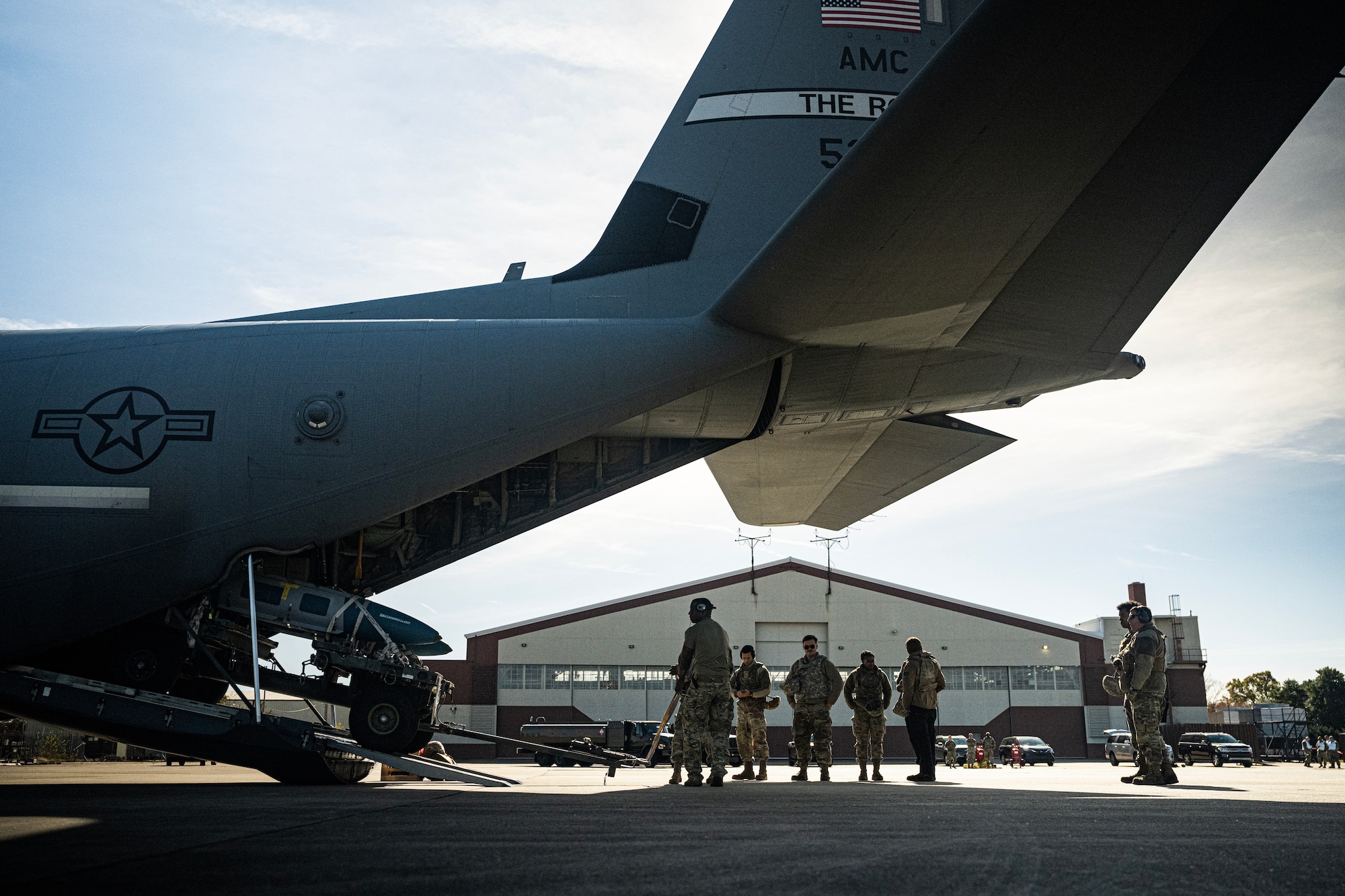 Airmen load into the back of a C-130J