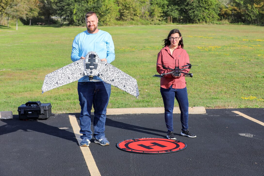 From right, Rebecca Capps, U.S. Army Corps of Engineers (USACE), Galveston District (SWG), physical scientist and drone operator, holds a Skydio X2D quadcopter and Roger Stillick, SWG drone operator, holds a SenseFly eBee TAC, outside the Jadwin Building, Nov. 20, 2023.