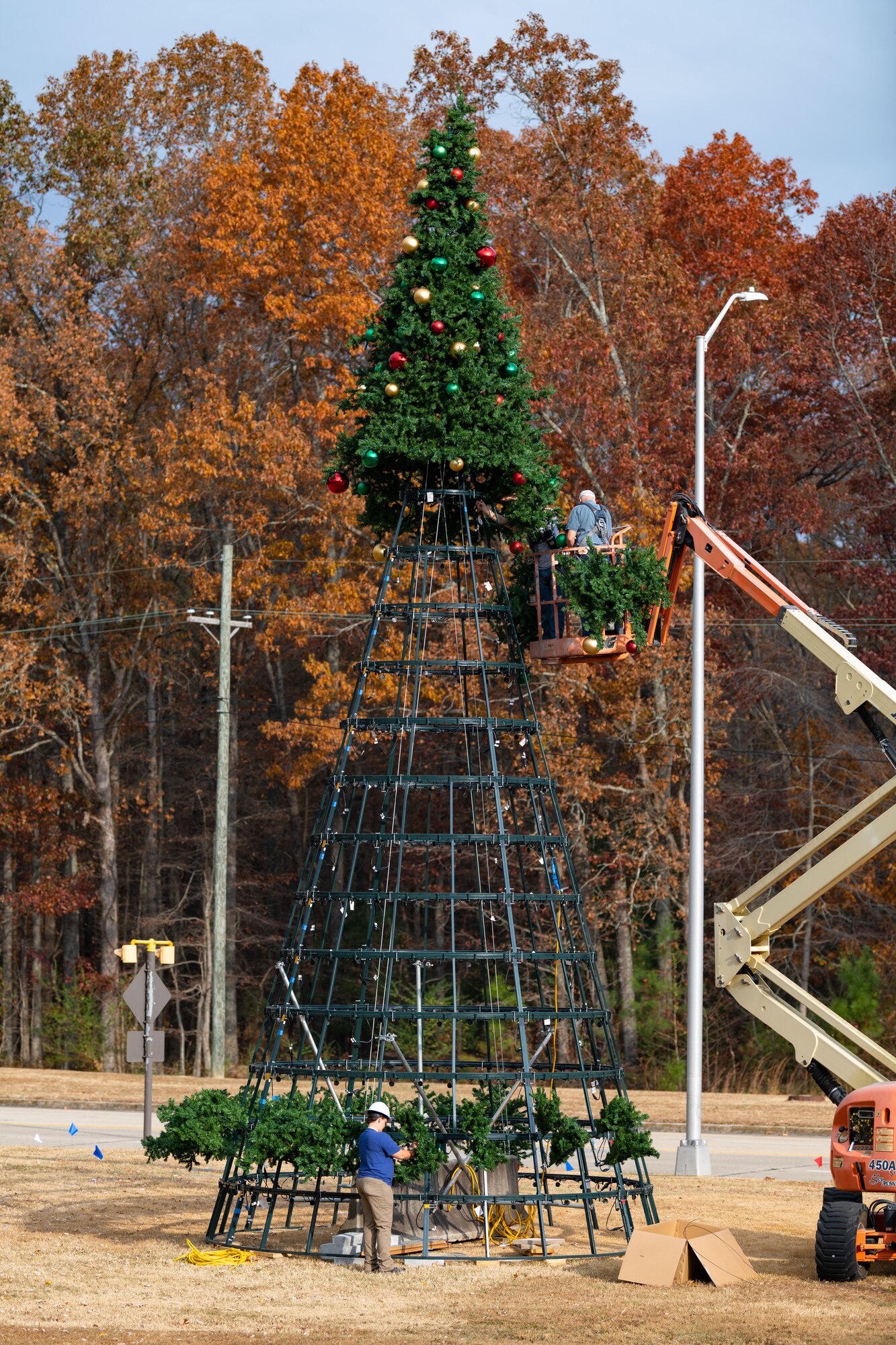 Arnold Air Force Base team members help assemble the large Christmas tree located just inside the Main Gate at Arnold AFB, Tenn, Nov. 9, 2023. A lighting ceremony for the 40-foot-tall, 22-foot-wide tree is scheduled for Dec. 4, 2023, at 4 p.m. (U.S. Air Force photo by Keith Thornburgh)