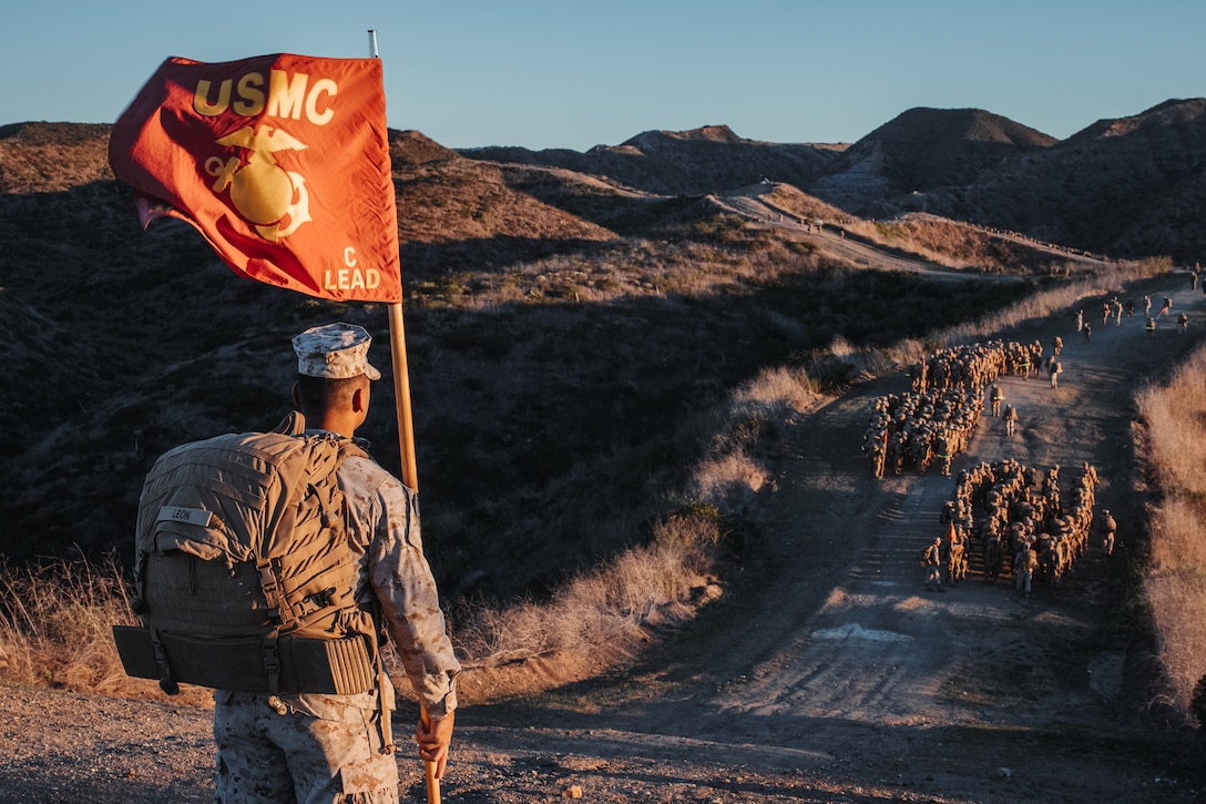 A U.S. Marine Corps drill instructor with Charlie Company, 1st Recruit Training Battalion, hikes the Reaper with his platoon, at Marine Corps Base Camp Pendleton, California, Nov. 21, 2023. The Reaper is the final portion of the Crucible which marks the transformation of recruits to Marines. (U.S. Marine Corps photo by Cpl. Alexander O. Devereux)