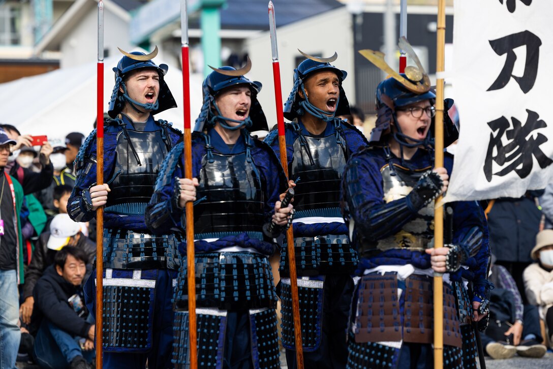 U.S. service members assigned to Marine Corps Air Station Iwakuni chant war cries during the annual Kuragake Castle Festival in Kuga Town, Iwakuni, Japan, Nov. 14, 2023. Iwakuni held the annual Kuragake Castle Festival and Samurai Parade to commemorate Lord Oyakata-sama and his men’s bravery during the Great Battle of Faith in 1555. (U.S. Marine Corps photo by Cpl. Isaac Orozco)