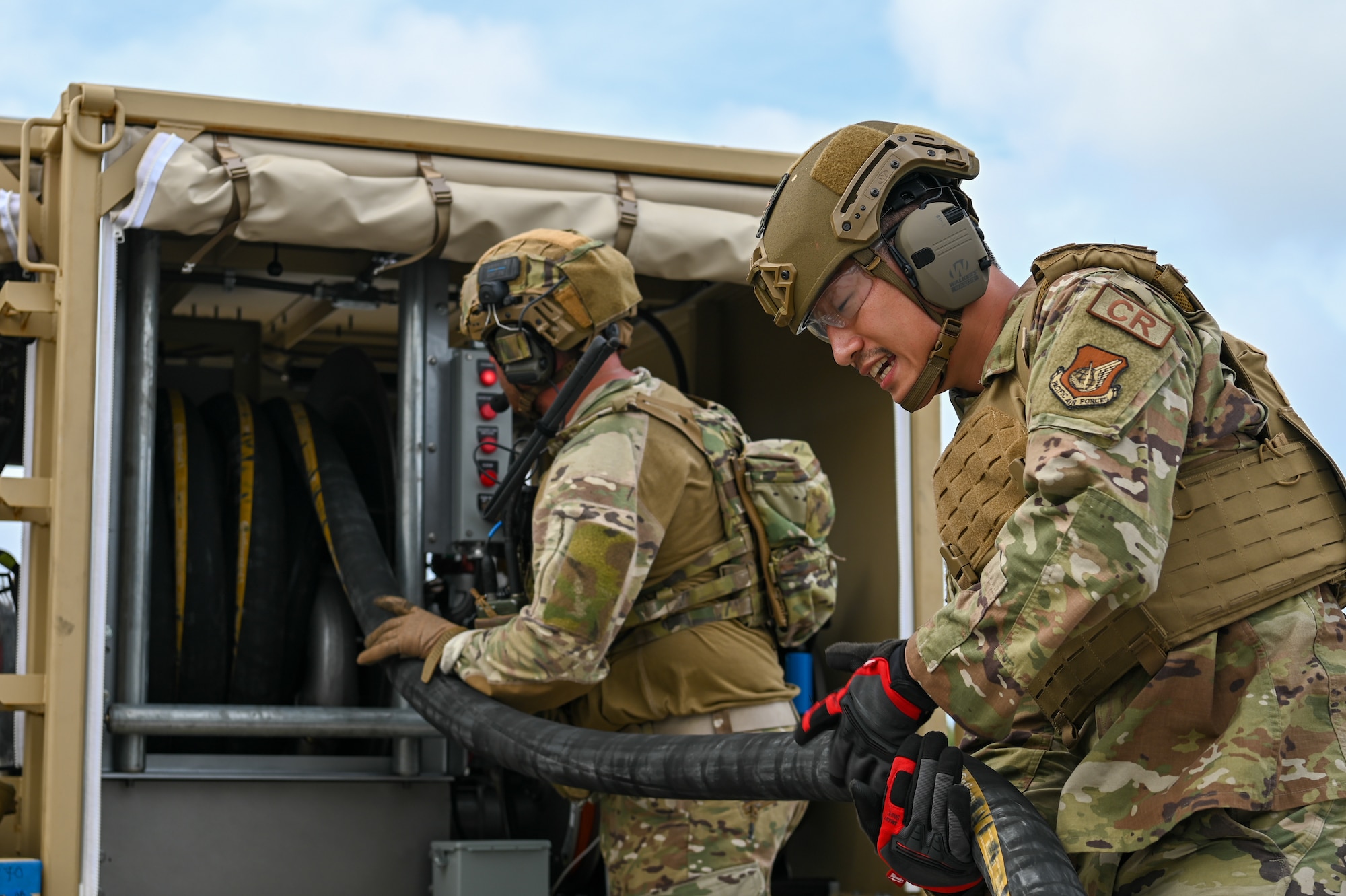 U.S. Air Force Airmen with the 36th Contingency Response Squadron unravel a fuel pump on Pacific Regional Training Center-Andersen, Guam, Nov. 17, 2023. Multiple squadrons assigned to the 36th Wing participated in a simulated deployment exercise to self-evaluate and gauge their skills in a deployed scenario to better accomplish the mission.(U.S. Air Force photo by Senior Airman Allison Martin)
