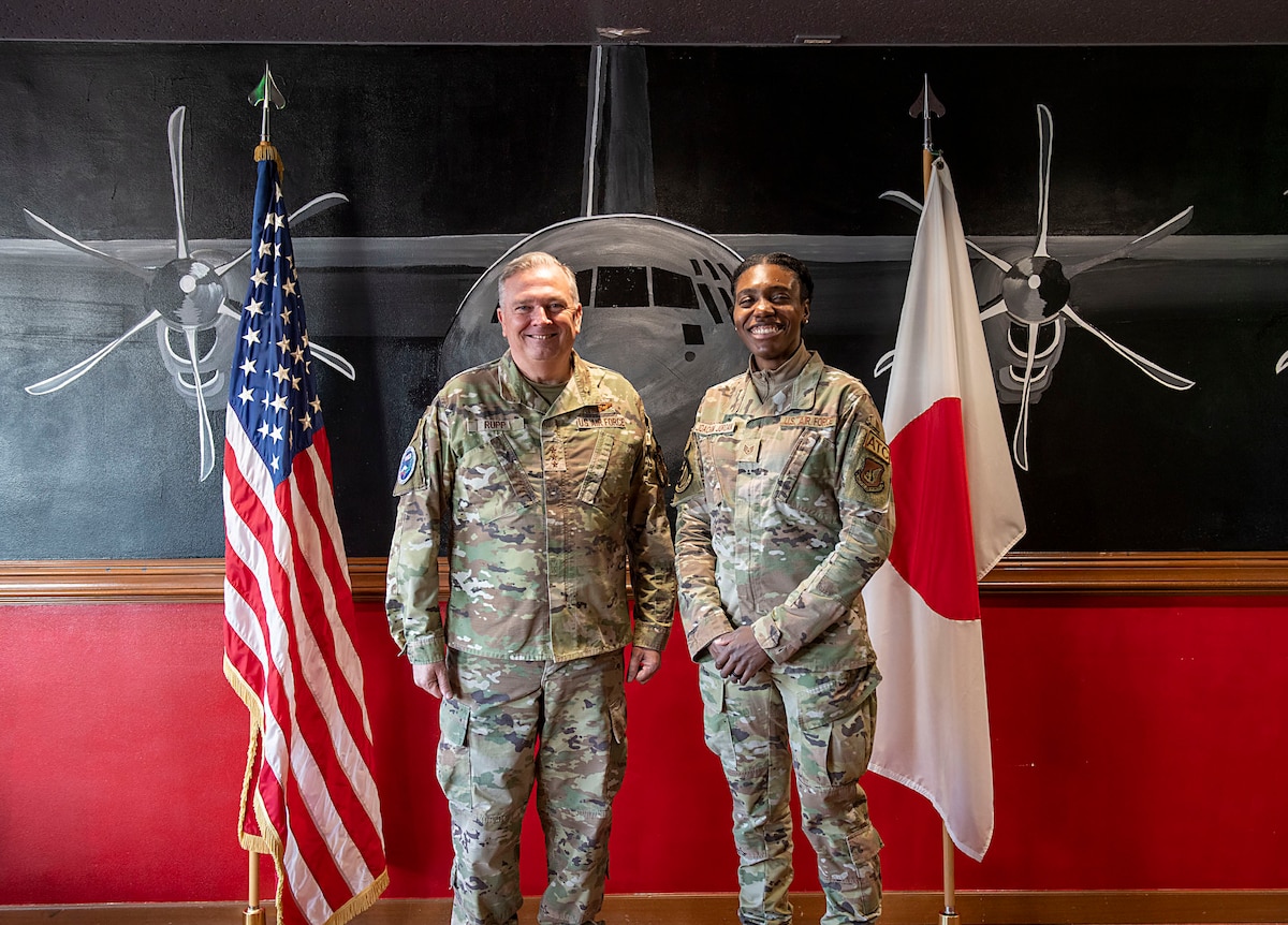 U.S. Air Force General and Airman stand next to each other for a photo