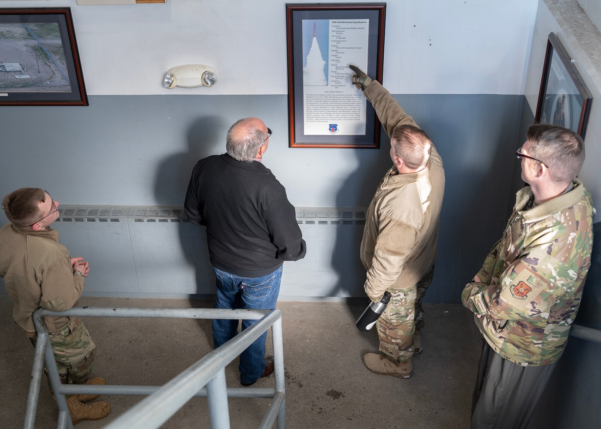 people looking at poster of missile diagnostics