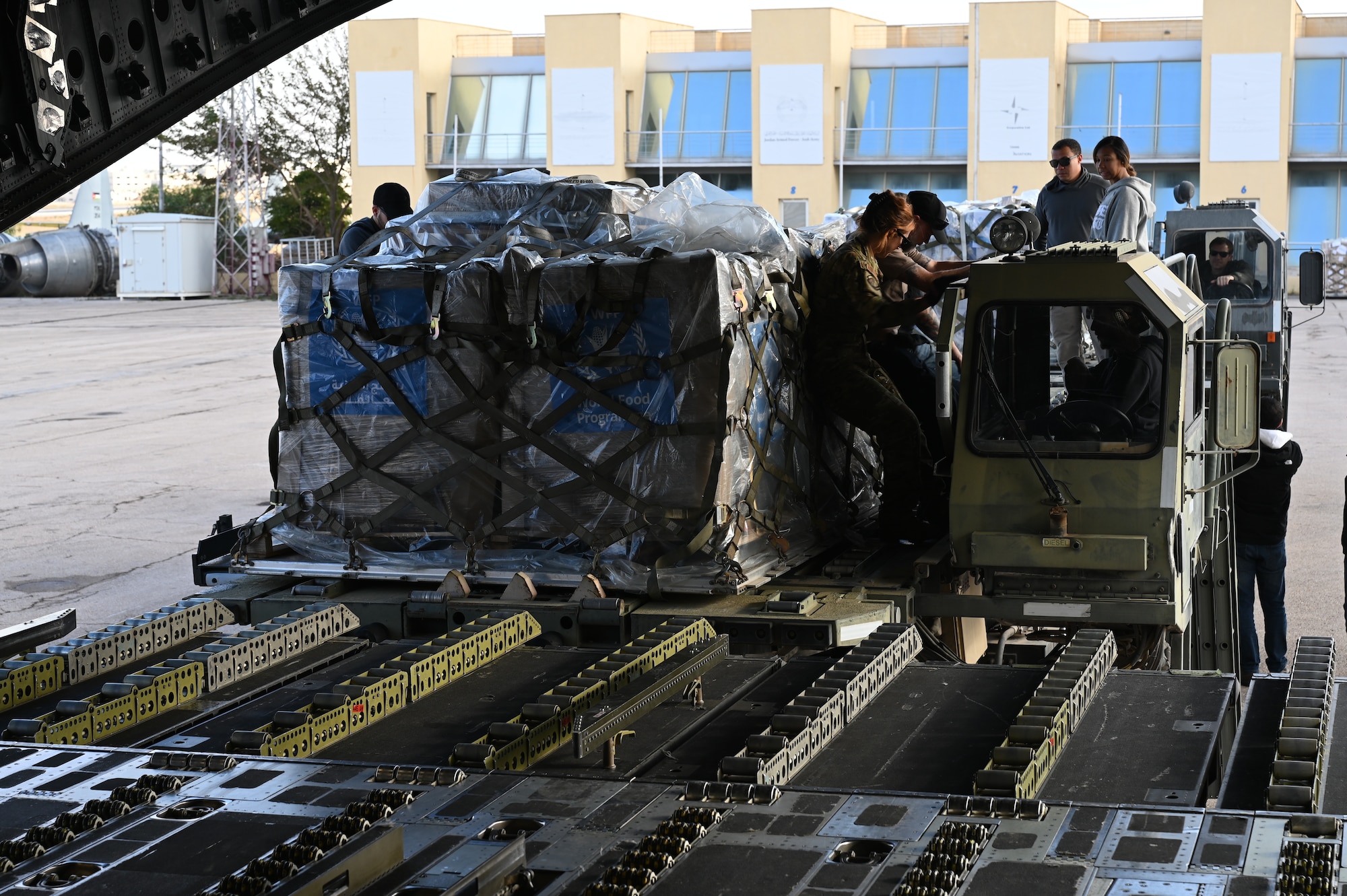 Aerial port specialists load 24.5 metric tons of humanitarian aid destined for Gaza aboard a C-17.