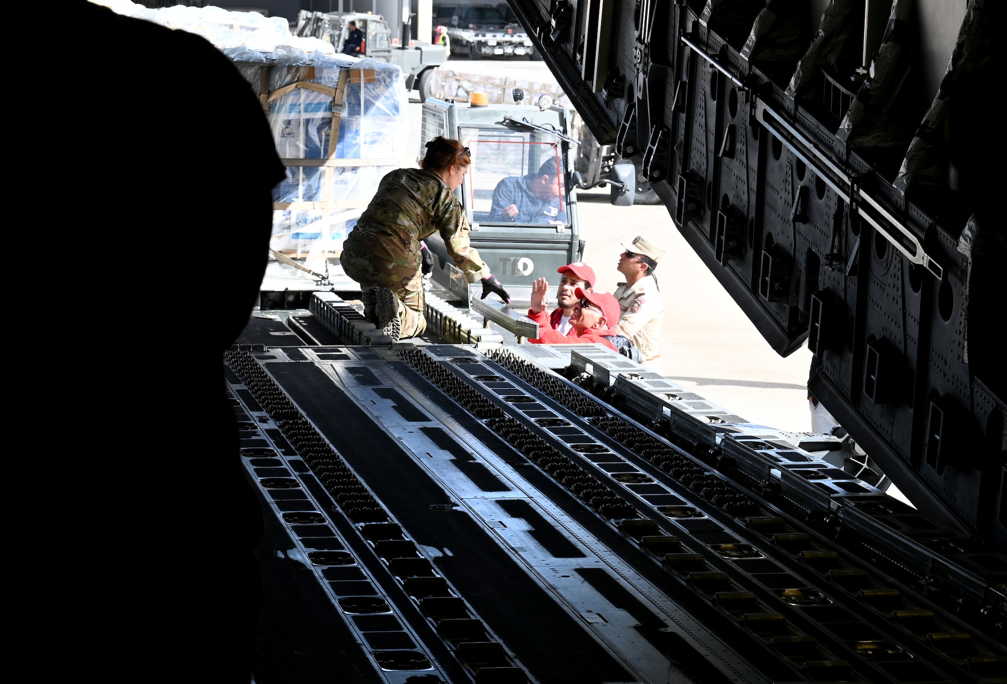 Staff Sgt. Jeanne Caron coordinates a humanitarian aid movement aboard a C-17 with U.S. Agency for International Development throughout the Middle East.