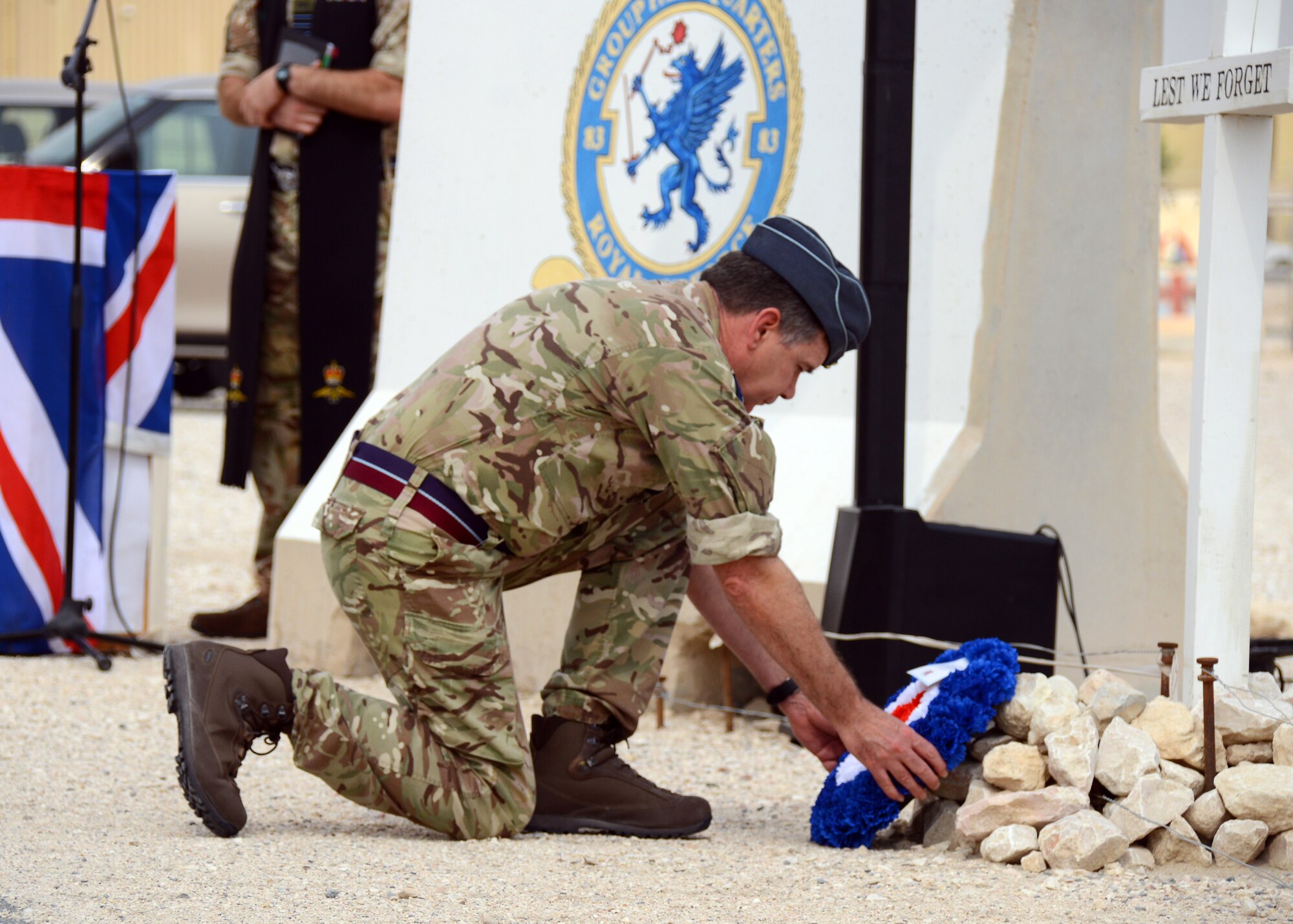 Air Vice-Marshal Tom Burke lays down a wreath at a memorial during a Remembrance Day ceremony.