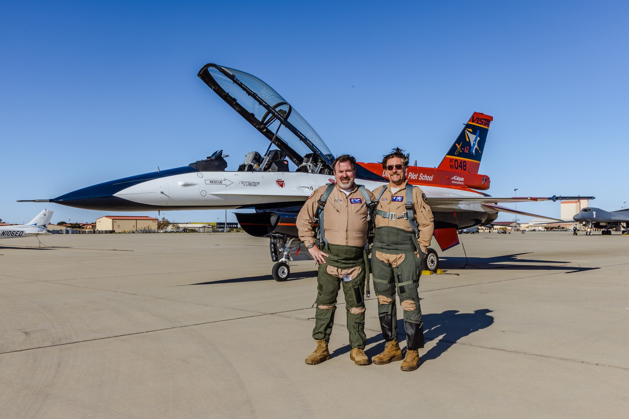 Dr. Christopher Cotting, the outgoing director of research at the U.S. Air Force Test Pilot School, and Bill Gray, TPS Chief Test Pilot, celebrate after Cotting's "fini-flight" with the X-62A Variable In-flight Simulation Test Aircraft on Edwards Air Force Base, California, Nov. 8. (Air Force photo by Lindsey Iniguez)