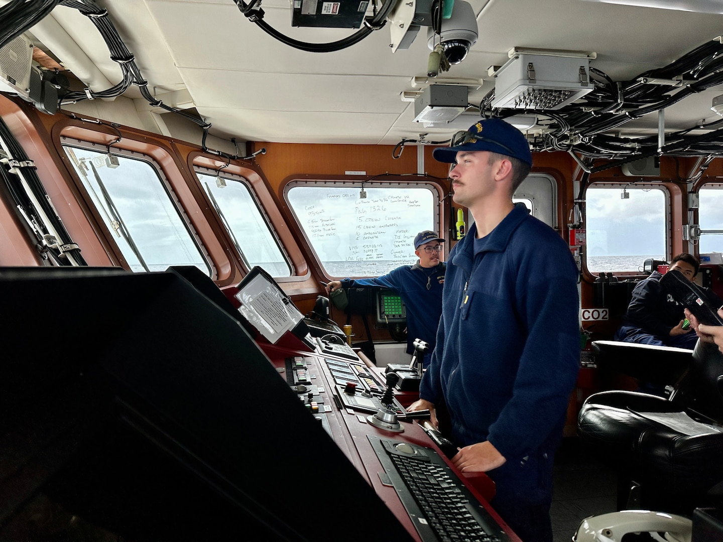Ensign Peyton Phillips at the helm of USCGC Myrtle Hazard (WPC 1139) in the Coral Sea off Papua New Guinea on Aug. 23, 2023. The U.S. Coast Guard was in Papua New Guinea at the invitation of the PNG government to join their lead in maritime operations to combat illegal fishing and safeguard marine resources following the recent signing and ratification of a bilateral maritime law enforcement agreement between the United States and Papua New Guinea. (U.S. Coast Guard photo by Chief Warrant Officer Sara Muir)