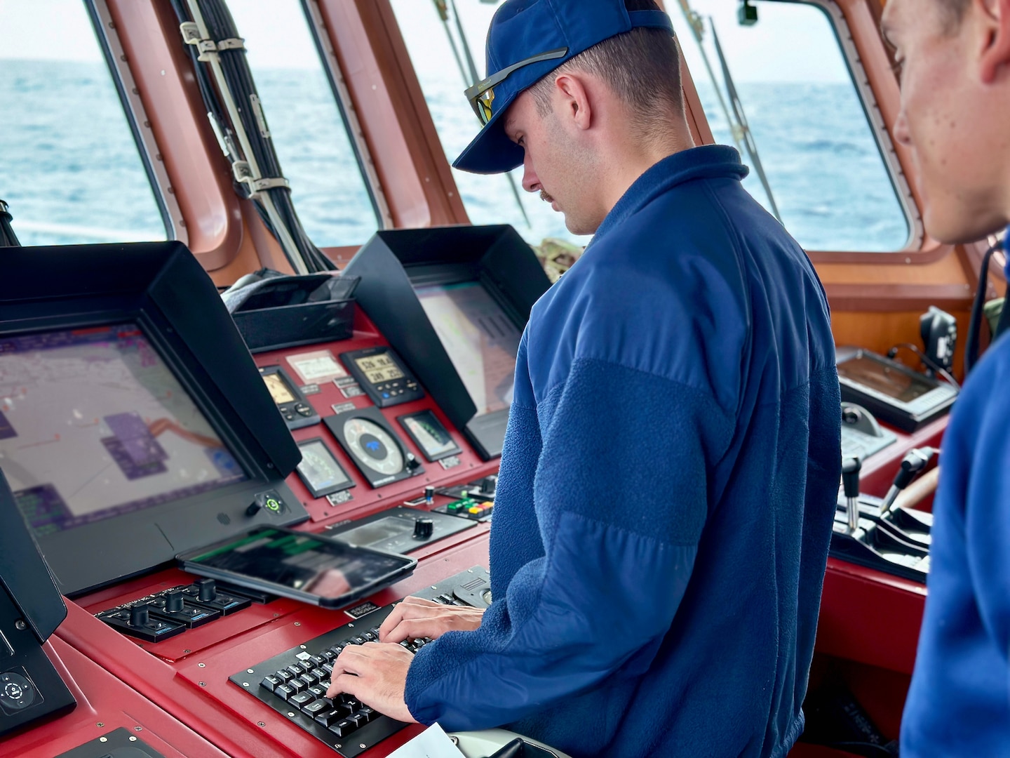 Ensign Peyton Phillips at the helm of USCGC Myrtle Hazard (WPC 1139) in the Coral Sea off Papua New Guinea on Aug. 23, 2023. The U.S. Coast Guard was in Papua New Guinea at the invitation of the PNG government to join their lead in maritime operations to combat illegal fishing and safeguard marine resources following the recent signing and ratification of a bilateral maritime law enforcement agreement between the United States and Papua New Guinea. (U.S. Coast Guard photo by Chief Warrant Officer Sara Muir)