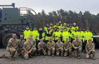 Soldier instructors from the 51st Composite Truck Company, 18th Combat Sustainment Support Battalion (first row), pose for a photo with Belgian host nation employees from Army Field Support Battalion-Benelux, 405th Army Field Support Brigade, during an Enhanced Heavy Equipment Transporter drivers academy held at the Zutendaal Army Prepositioned Stocks-2 worksite, Belgium, in November. Also pictured here is 405th AFSB Command Sgt. Maj. Terrell Brisentine and AFSBn-Benelux Sgt. Maj. Alejandro Romar. (U.S. Army courtesy photo)
