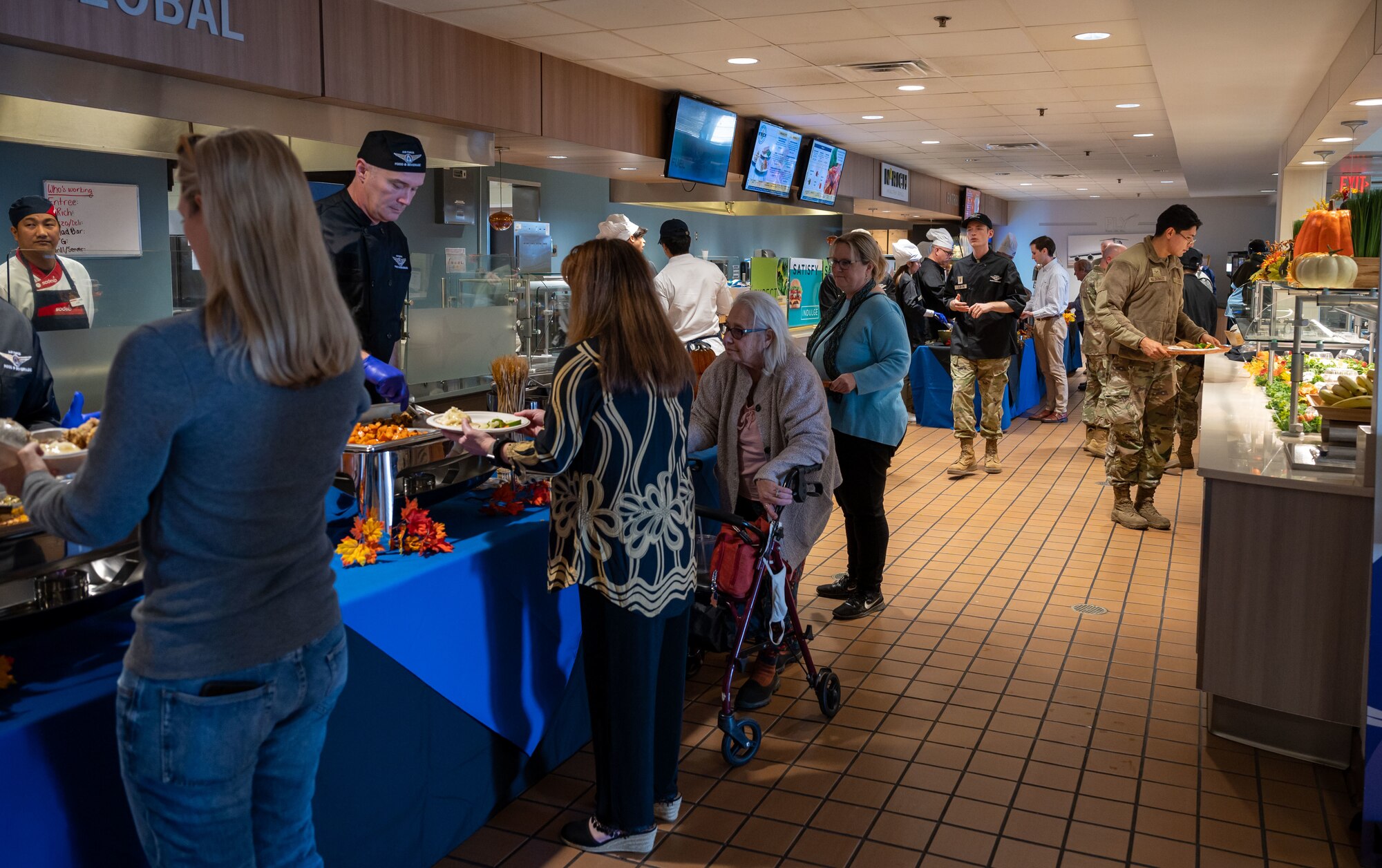 Team Dover members wait in line for their Thanksgiving lunch at Dover Air Force Base, Delaware, Nov. 23, 2023. Team Dover gathered together to share a Thanksgiving meal prepared by the Wright Patterson Dining Facility staff. (U.S. Air Force photo by Airman 1st Class Amanda Jett)