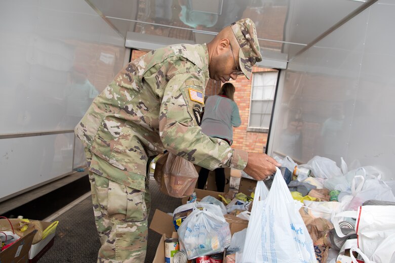 Col. Christian Patterson, commander of the U.S. Army Engineer Research and Development Center (ERDC), helps load food donations into a delivery truck during ERDC Under the Lights, the organization’s holiday lights drive-thru event. Now in its seventh year, the annual event is a way for ERDC employees to give back to the community. (U.S. Army Corps of Engineers photo by Jared Eastman)