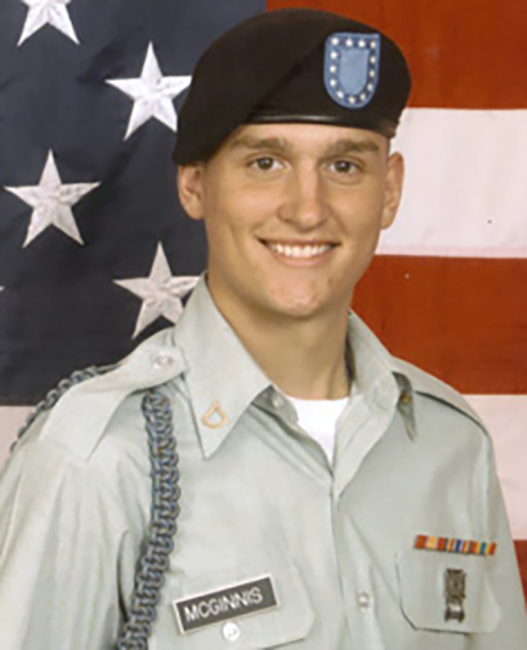 A man in uniform smiles for the camera.
