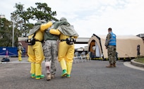 Joint Base Charleston Airmen participate in a medical exercise where they act as patients with simulated wounds. Medical Group staff wear protective hear as they treat the simulated patients.