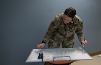 Joint Base Charleston Airmen participate in a medical exercise where they act as patients with simulated wounds. Medical Group staff wear protective hear as they treat the simulated patients.