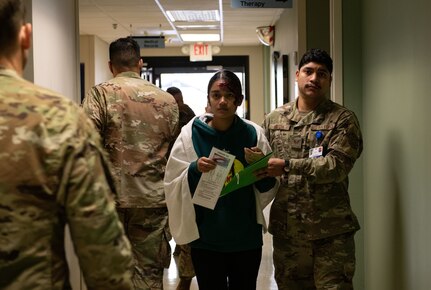 Joint Base Charleston Airmen participate in a medical exercise where they act as patients with simulated wounds. Medical Group staff wear protective hear as they treat the simulated patients.