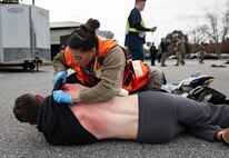 Joint Base Charleston Airmen participate in a medical exercise where they act as patients with simulated wounds. Medical Group staff wear protective hear as they treat the simulated patients.