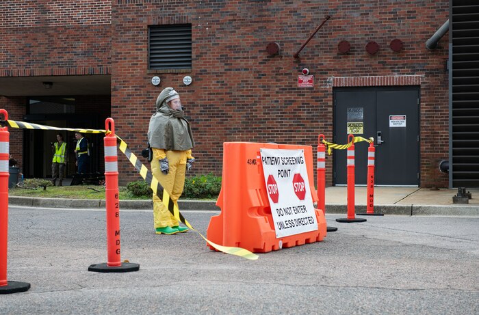 Joint Base Charleston Airmen participate in a medical exercise where they act as patients with simulated wounds. Medical Group staff wear protective hear as they treat the simulated patients.