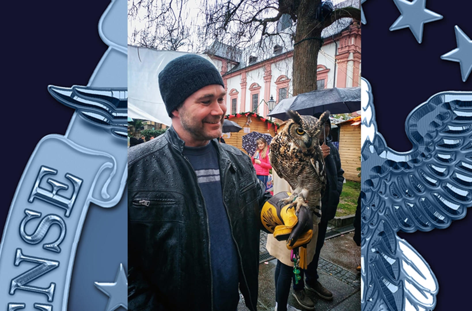 A man lets an owl perch on his outstretched arm.