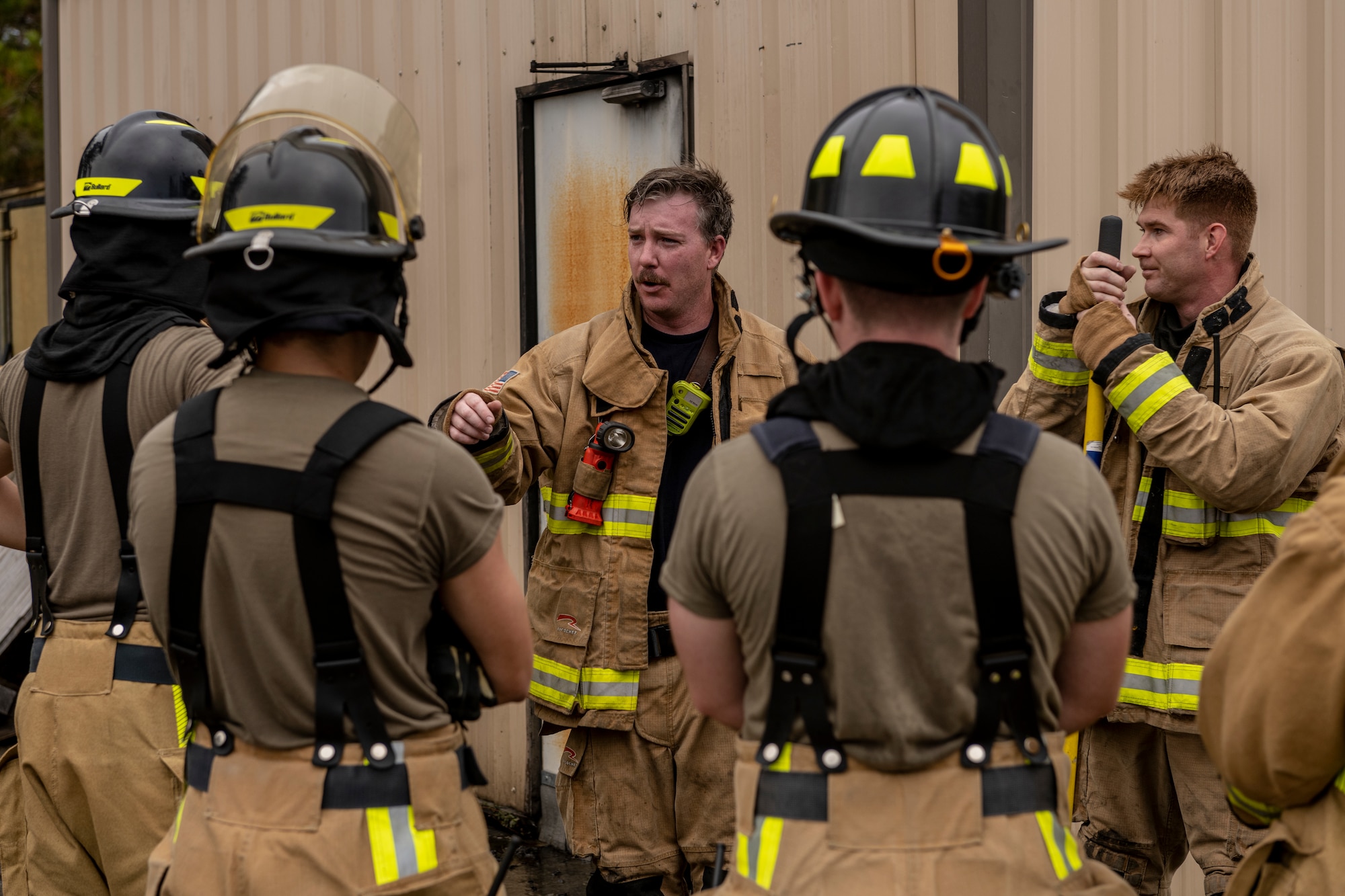 Christopher Hobbs, 23rd Civil Engineer Squadron firefighter, provides a debrief after live-fire training