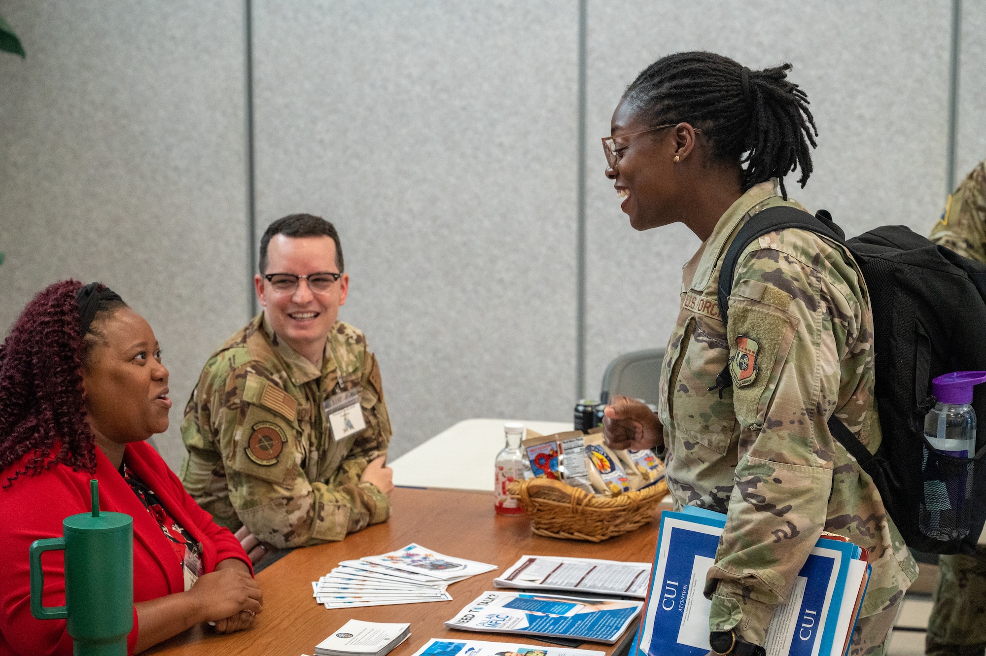 U.S. Air Force Maj. Temidire Oluwaloba, 45th Operational Medical Readiness Squadron public health flight commander, speaks with members of the Military Family Readiness Center during a personnel deployment function line at Patrick Space Force Base, Florida, Oct. 5 2023. The 45th Logistics Readiness Squadron hosted its first PDF line, used to help streamline the pre-deployment process for service members, in more than 13 years. (U.S. Space Force photo by Airman 1st Class Spencer Contreras)