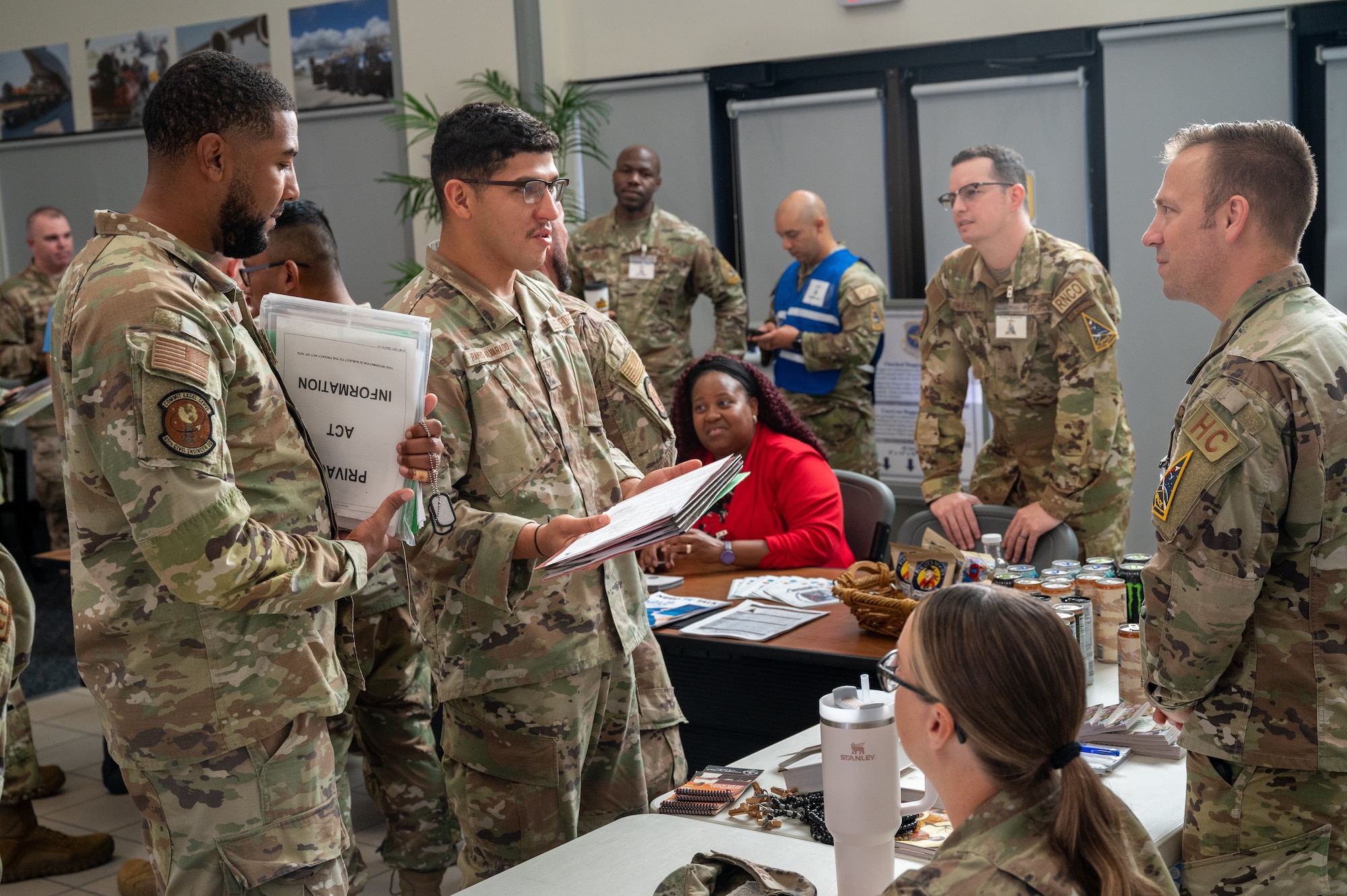 Members of the 45th Civil Engineer Squadron talk with base support agencies during a personnel deployment function line at Patrick Space Force Base, Florida, Oct. 5 2023. The 45th Logistics Readiness Squadron hosted its first PDF line, used to help streamline the pre-deployment process for service members, in more than 13 years. (U.S. Space Force photo by Airman 1st Class Spencer Contreras)
