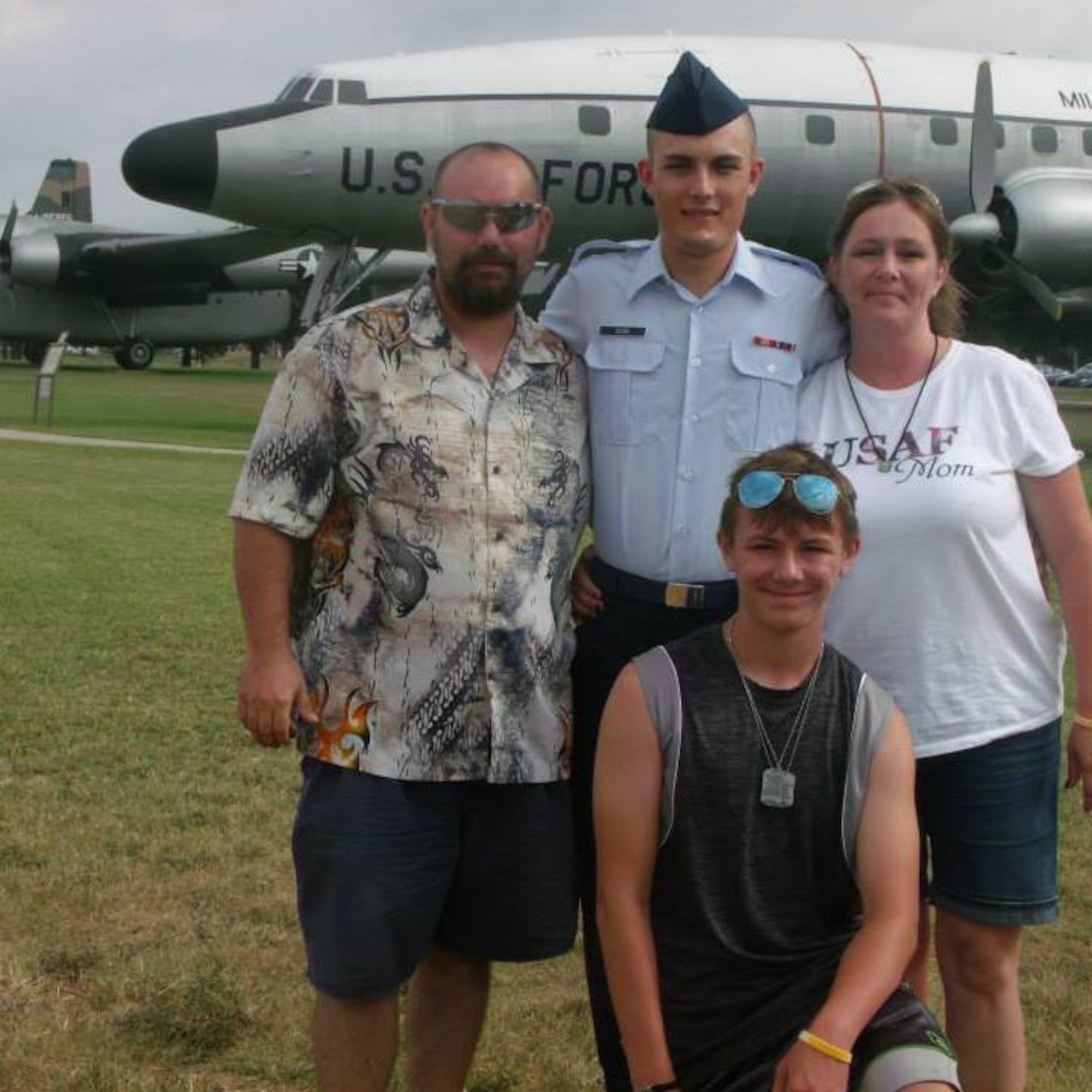 Then U.S. Airman Basic Jacob Beebe, center, poses with his family, Orin Pickering, left, Linda Pickering, right, and Dylan Pickering, front, at Joint Base San Antonio-Lackland, Texas, in July 2015.