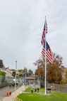 Members of a Puget Sound Naval Shipyard & Intermediate Maintenance Facility color guard raise a new American flag Nov. 9, 2023, during a special Veterans Day flag-replacement ceremony near the State Street Gate Entrance at PSNS & IMF in Bremerton, Wash. The event was hosted by the Veterans Employee Resource Group. (U.S. Navy photo by Jeb Fach)