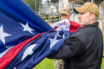 Sailors participate in a special flag-replacement ceremony Nov. 9, 2023, near the State Street Gate Entrance at Puget Sound Naval Shipyard & Intermediate Maintenance Facility in Bremerton, Wash. (U.S. Navy photo by Ben Hutto)
