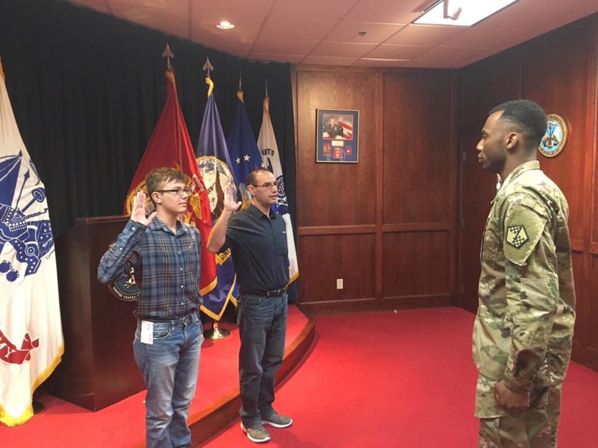 From left, Dylan and Orin Pickering recite the Oath of Enlistment prior to joining the U.S. Air Force, at the Military Entrance Processing Station in Syracuse, New York, in November 2017.