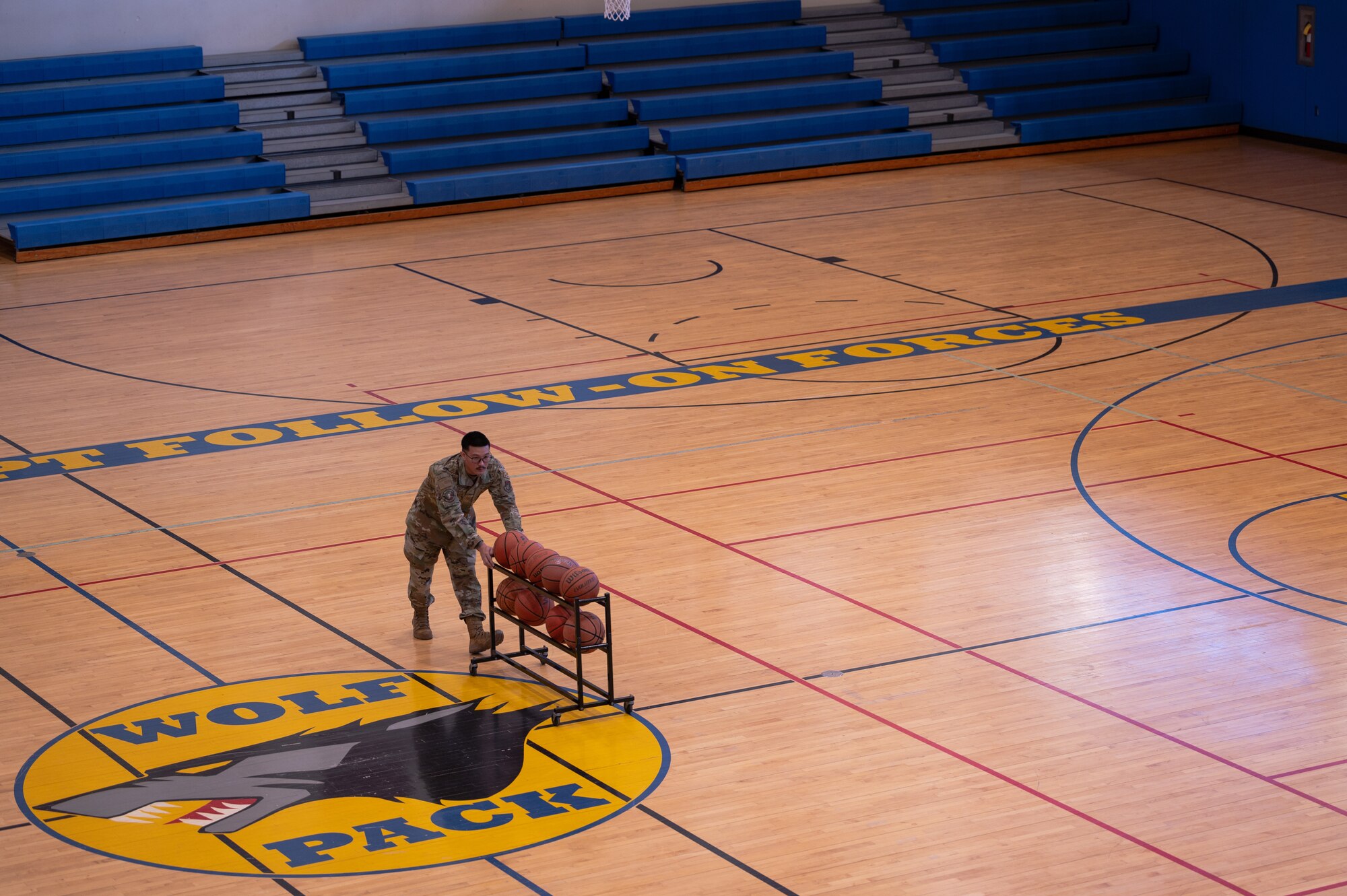 Senior Airman Jose Arcilla performs routine maintenance within the fitness center.