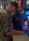 NAPLES, Italy. -  Rear Adm. Stephen Mack, commander, Submarine Group 8, writes a message in the ships’ guest book before departing the Italian Todaro-class submarine, Scirè (S 527), during U.S. and Italian Navy undersea warfare staff talks, in Naples Italy, Nov. 20, 2023. While in Naples, the Scirè hosted Italian Navy Rear Adm. Vito Lacerenza, Commander of the Submarines, and Rear Adm. Mack, further strengthening the U.S. and Italian partnership. (U.S. Navy photo by Mass Communication Specialist 1st Class Ryan Seelbach)