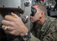 NAPLES, Italy. -  Capt. Ben Selph, deputy commander, Submarine Group 8, uses a periscope aboard the Italian Todaro-class submarine, Scirè (S 527), during U.S. and Italian Navy undersea warfare staff talks, in Naples Italy, Nov. 20, 2023. While in Naples, the Scirè hosted Italian Navy Rear Adm. Vito Lacerenza, Commander of the Submarines, and Rear Adm. Mack, further strengthening the U.S. and Italian partnership. (U.S. Navy photo by Mass Communication Specialist 1st Class Ryan Seelbach)
