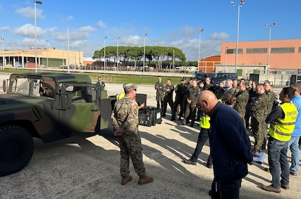 Chief Warrant Officer 3 Colin Rose, Army Field Support Battalion-Africa’s chief of quality assurance, briefs a group of Polish military personnel at Leghorn Army Depot in Livorno, Italy, to help them better understand how an Army Prepositioned Stocks-2 worksite operates. The Polish logistics support workforce who visited Leghorn are set to take responsibility of the new APS-2 worksite in Powidz, Poland, in the next year or two. They came to Leghorn to see what a well-managed APS-2 worksite looks like. (Photo by Maj. Duane Dumlao)