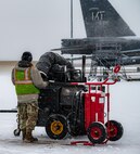 A 5th Aircraft Maintenance Squadron crew chief waits by a heater cart before starting pre-flight procedures for a B-52H Stratofortress at Minot Air Force Base, North Dakota, Nov. 27, 2023. 5th AMXS crew chiefs work around the clock in all-weather conditions to provide B-52H Stratofortress firepower on demand.(U.S. Air Force photo by Airman 1st Class Alexander Nottingham)