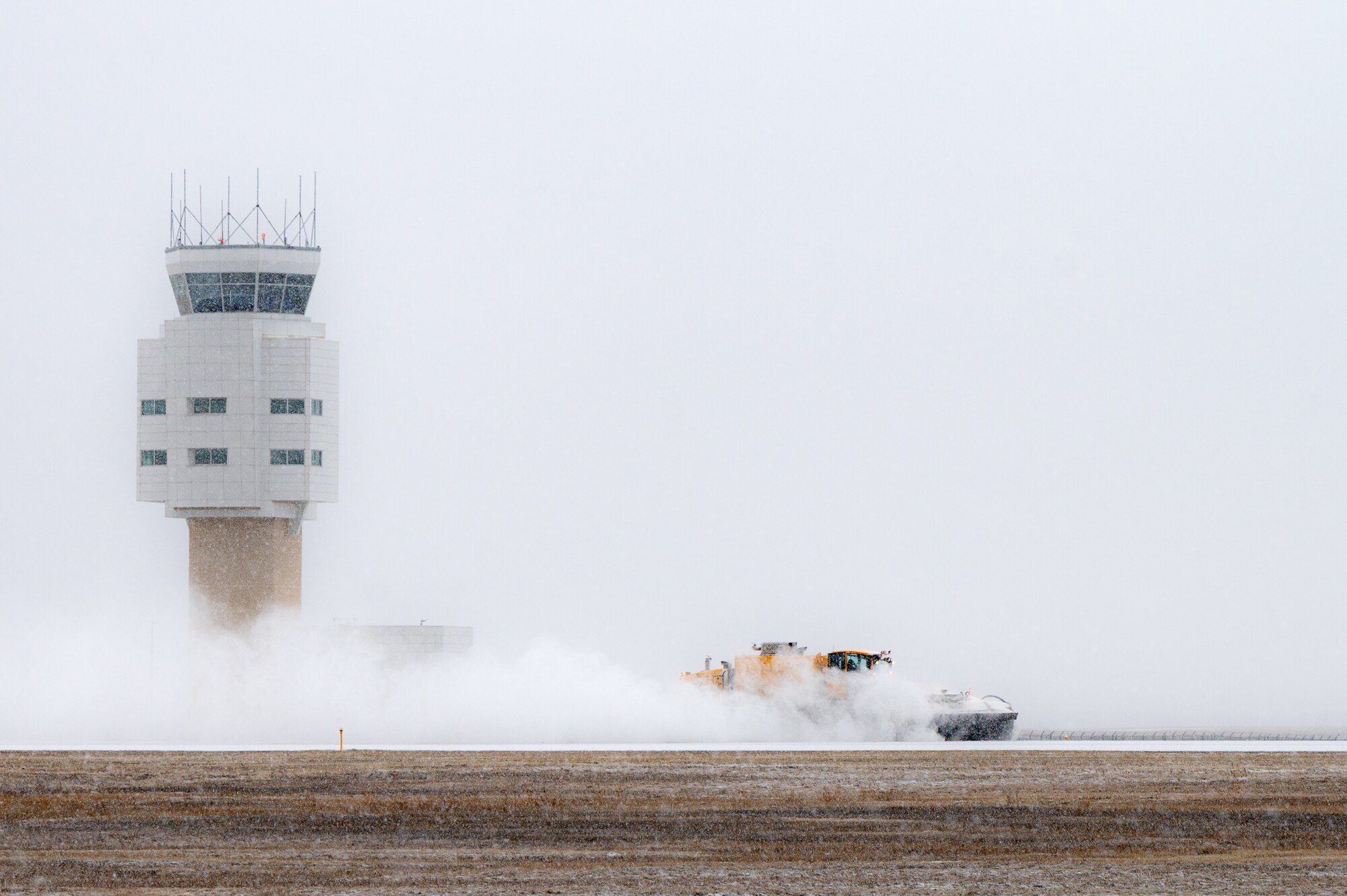 Members of the 5th Civil Engineer Squadron work to remove snow from the flight line at Minot Air Force Base, North Dakota, Nov. 27, 2023. The 5th CE tends to base snow removal efforts to prevent delays in base operations. (U.S. Air Force photo by Airman 1st Class Alexander Nottingham)