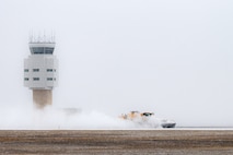 Members of the 5th Civil Engineer Squadron work to remove snow from the flight line at Minot Air Force Base, North Dakota, Nov. 27, 2023. The 5th CE tends to base snow removal efforts to prevent delays in base operations. (U.S. Air Force photo by Airman 1st Class Alexander Nottingham)