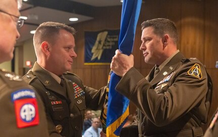 Brig. Gen. Christopher Schneider, Program Executive Officer Soldier, passes the organizational colors of Program Manager Soldier Lethality to the newly assigned Col. Jason Bohannon, PM SL, officially relinquishing authority from the outgoing officer Col. (RET) Scott Madore, 4 Aug. 2023 at Picatinny Arsenal, NJ. (Photo by Jesse Glass)