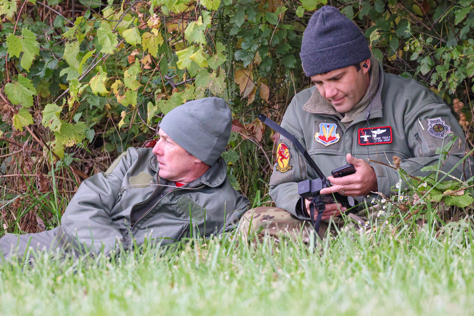 Two Airmen in a field.